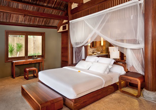 L'Ayla Ninh Van Bay lagoon villa bedroom, double bed with canopy, wooden panelling and decor