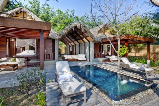 L'Ayla Ninh Van Bay lagoon villa exterior, pool, sun loungers, trees in background