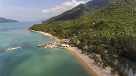 L'Ayla Ninh Van Bay resort, aerial shot of beachside resort with pool, villa nestled in tropical hillside