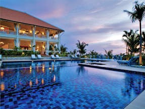 La Veranda Vietnam pool sun loungers palm trees hotel building
