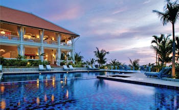 La Veranda Vietnam pool sun loungers palm trees hotel building