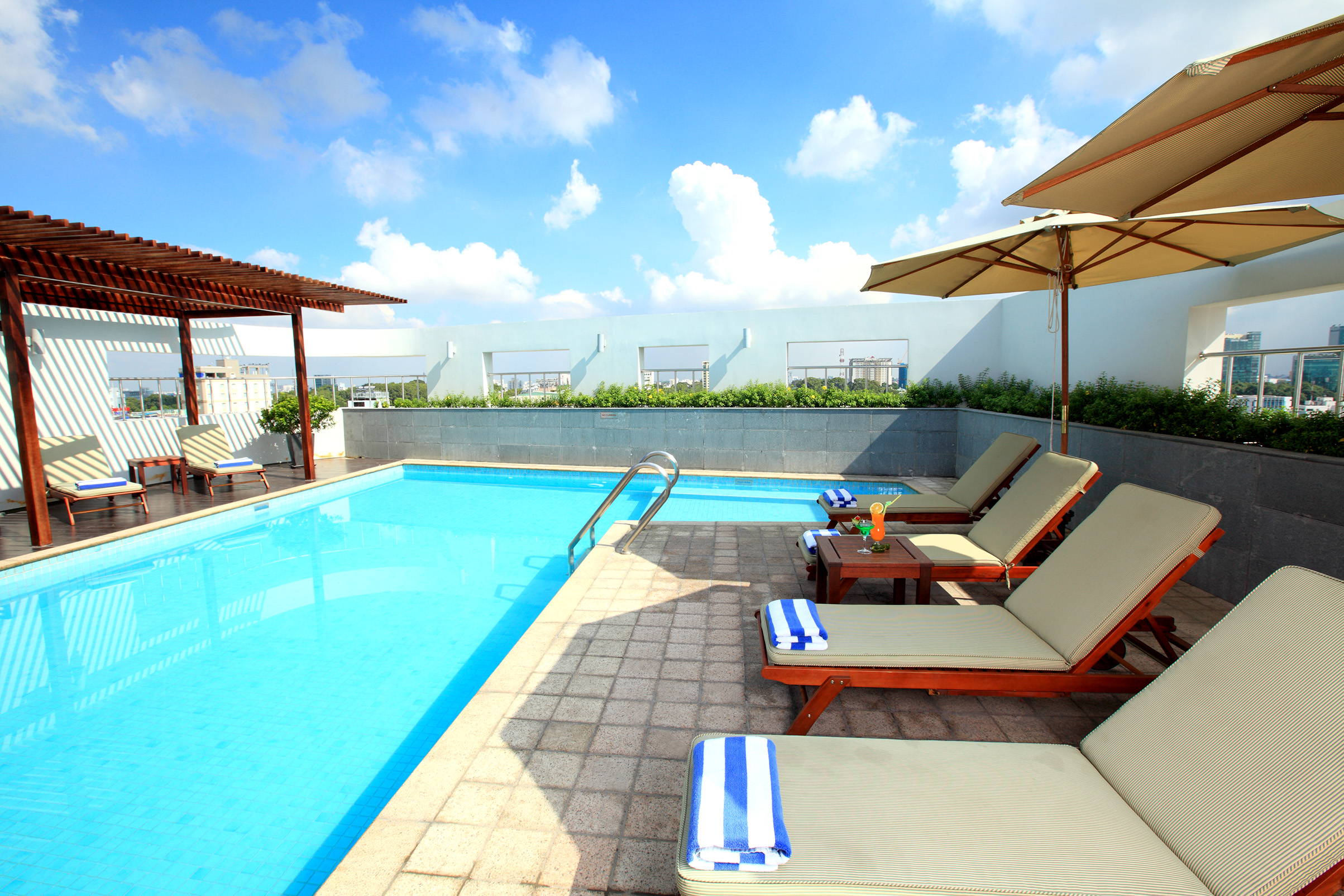 Liberty Central Saigon rooftop pool, sun loungers, umbrellas