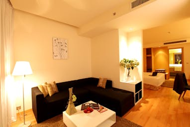 Liberty Central Saigon suite, living area, sofa, bedroom, bright modern decor 