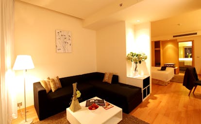 Liberty Central Saigon suite, living area, sofa, bedroom, bright modern decor