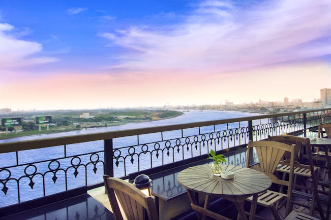 Majestic Hotel Saigon terrace, bar outdoor seating area with view over river