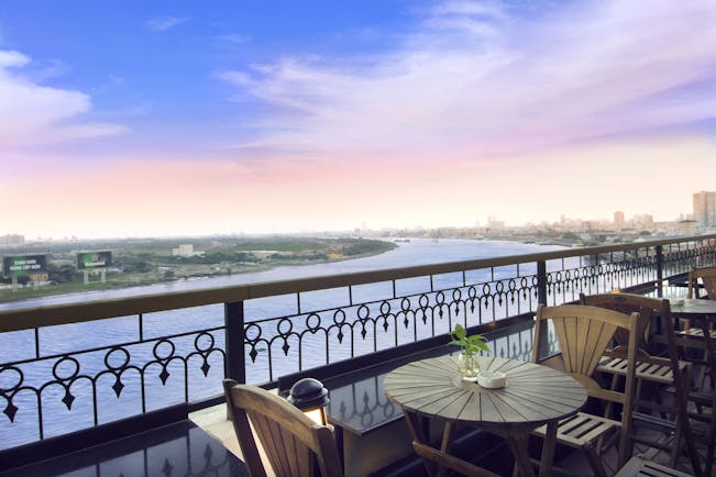 Majestic Hotel Saigon terrace, bar outdoor seating area with view over river