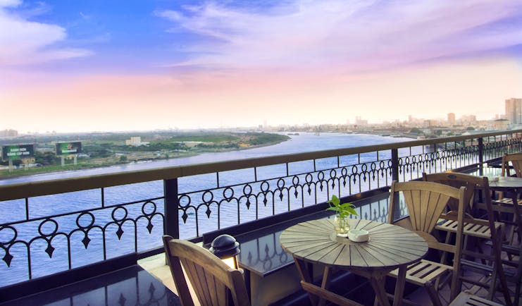 Majestic Hotel Saigon terrace, bar outdoor seating area with view over river