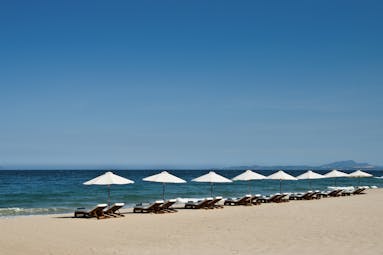 Mia Nha Trang Resort beach loungers, white sandy beach, clear blue sea, loungers and umbrellas