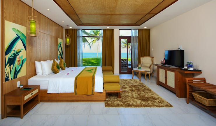 Palm Garden Resort deluxe room, double bed, television, bright modern decor