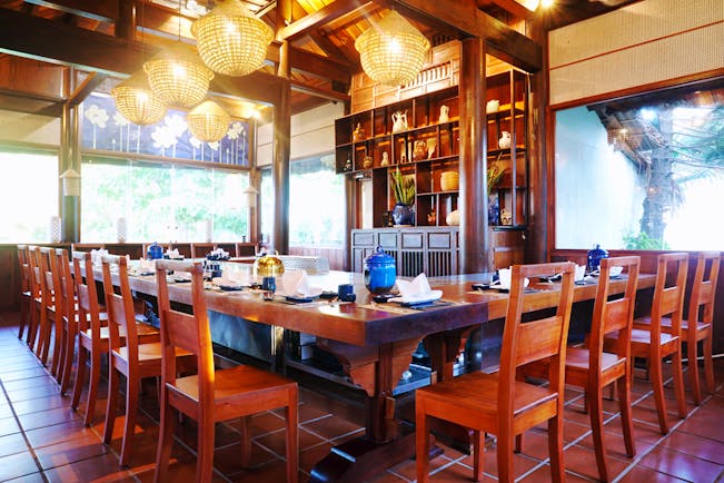Palm Garden Resort restaurant indoor dining, traditional decor, wooden roof beams, ornate table