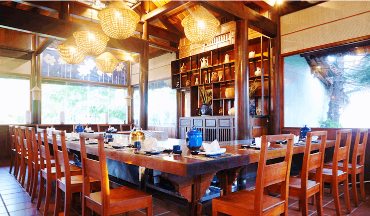 Palm Garden Resort restaurant indoor dining, traditional decor, wooden roof beams, ornate table