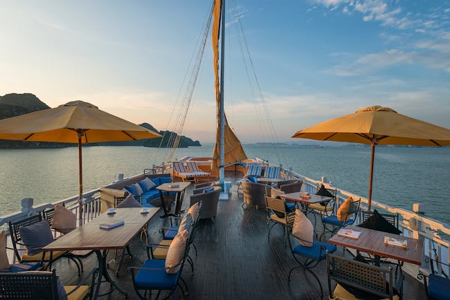 Paradise Luxury Cruise sun deck, tables and chairs on top deck of boat, views over the sea