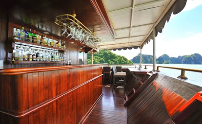 Paradise Peak Cruise bar on back deck of boat, views over sea, rock formation in background