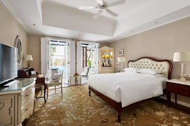 Park Hyatt Saigon deluxe room, double bed, desk, french windows leading to balcony, elegant decor