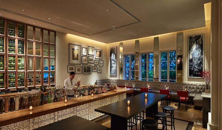 Park Hyatt Saigon opera bar, elegant modern decor, bartender mixing drinks, 