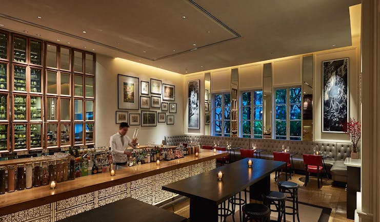 Park Hyatt Saigon opera bar, elegant modern decor, bartender mixing drinks,