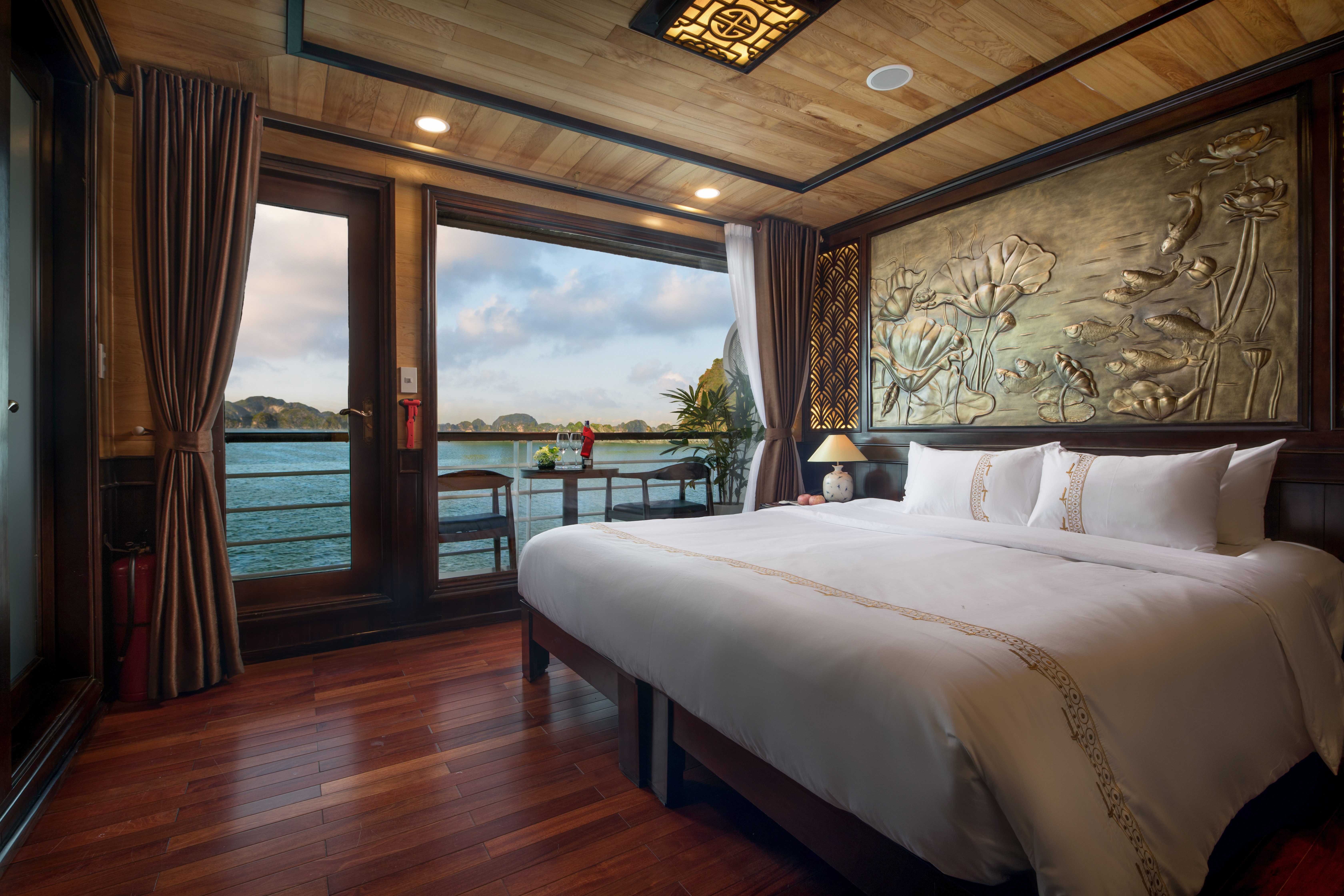 Perla Dawn Sails Cruise double room, bed, traditional decor, floral wall engraving, large windows with view over sea