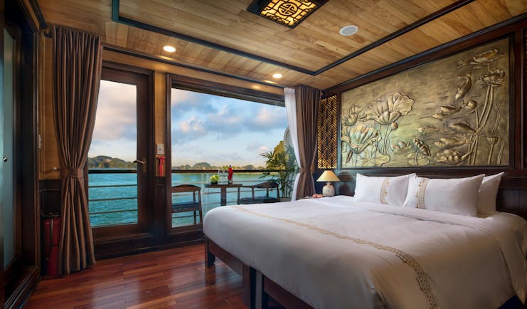 Perla Dawn Sails Cruise double room, bed, traditional decor, floral wall engraving, large windows with view over sea