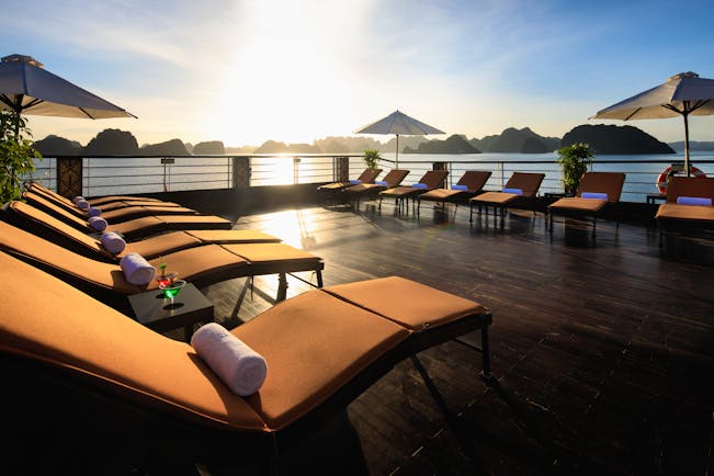 Perla Dawn Sails Cruise sundeck, sun loungers, umbrellas, views over the bay