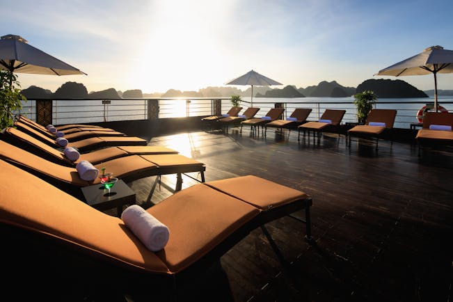 Perla Dawn Sails Cruise sundeck, sun loungers, umbrellas, views over the bay