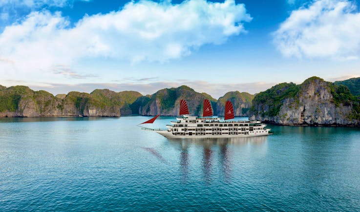 President Cruise boat on water, rock formations in background