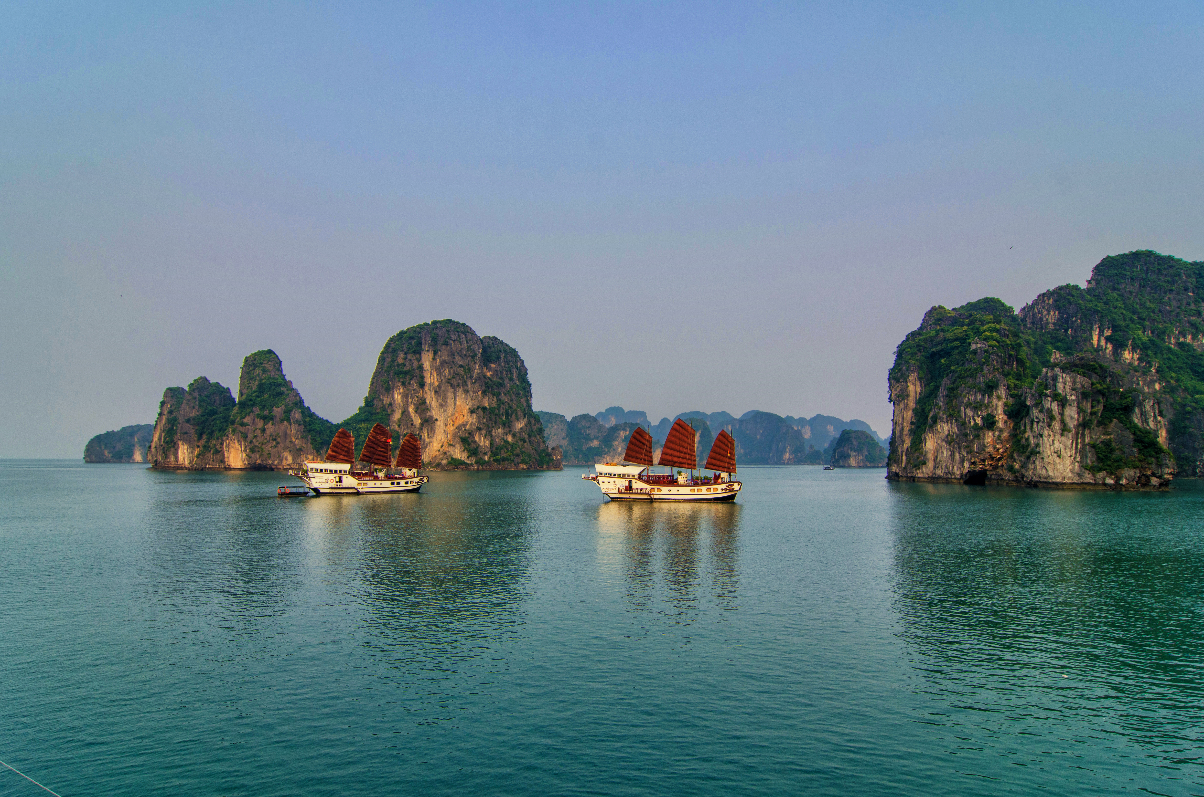 Red Dragon Junk cruise, two boats on water in Ha Long Bay