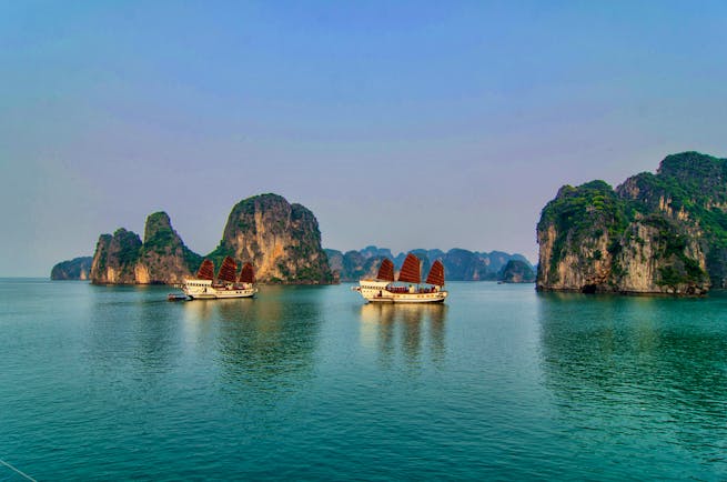Red Dragon Junk cruise, two boats on water in Ha Long Bay