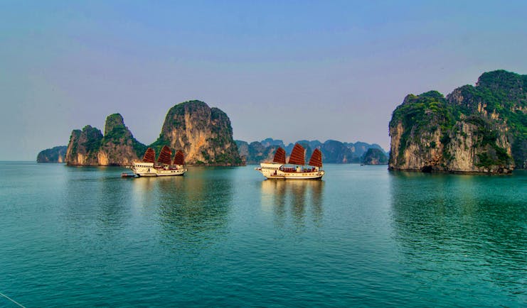 Red Dragon Junk cruise, two boats on water in Ha Long Bay