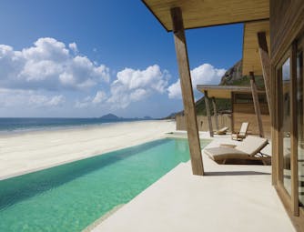 Six Senses Vietnam ocean front villa exterior infinity pool terrace sun lounger