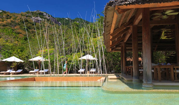 Six Senses Ninh Van Bay Vietnam outdoor pool loungers umbrellas covered seating area 