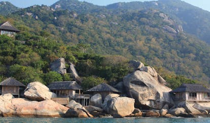 Six Senses Ninh Van Bay Vietnam rock villas exterior shot thatched roofed buildings ocean wooded hillside