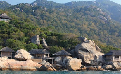 Six Senses Ninh Van Bay Vietnam rock villas exterior shot thatched roofed buildings ocean wooded hillside