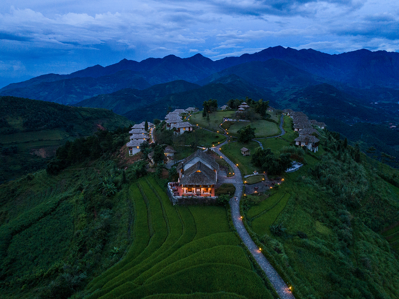 Topas Ecolodge resort, hotel buildings nestled onto hillside, mountains in background