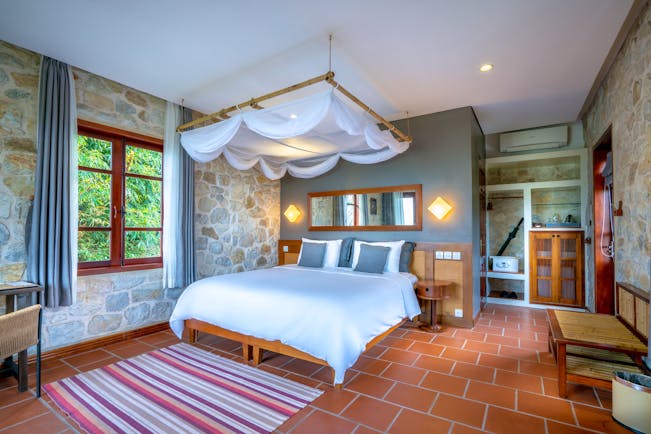 Topas Ecolodge premium bungalow bedroom, double bed, canopy, elegant decor