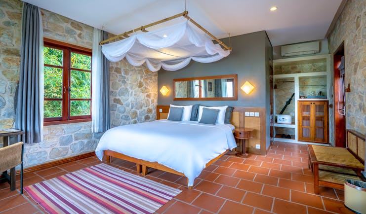 Topas Ecolodge premium bungalow bedroom, double bed, canopy, elegant decor