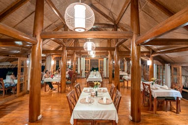 Topas Ecolodge restaurant, modern dining area, exposed wood beams, tables and chairs