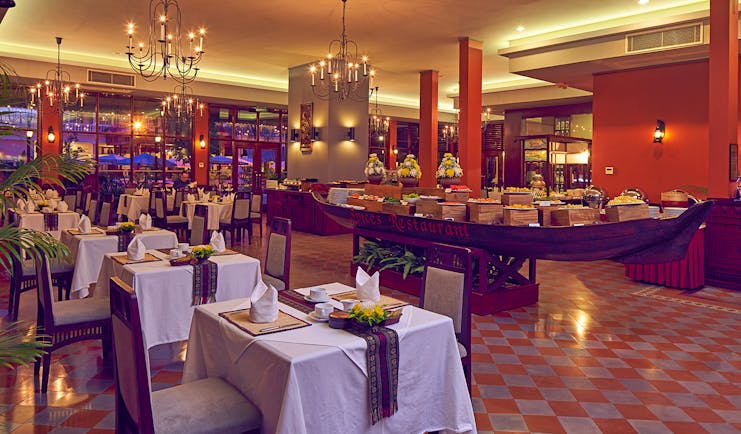 Victoria Can Tho Resort restaurant, traditional decor, tables and chairs, chandeliers