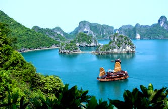 Ha Long Bay, junk boat on the water, surrounded by rock formations, sea 
