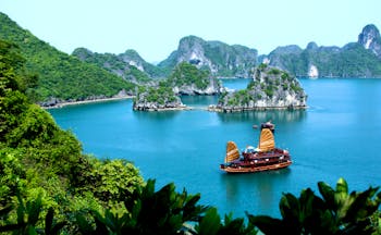 Ha Long Bay, junk boat on the water, surrounded by rock formations, sea 
