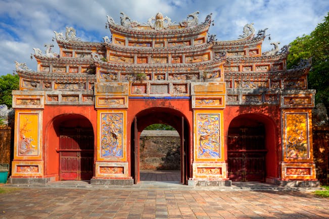 Gate at the imperial city citadel in Hue, colourful structure with carvings and paintings