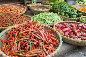 Vegetables for sale at a market in Hanoi, chillies, peppers, green beans tomatoes, onions