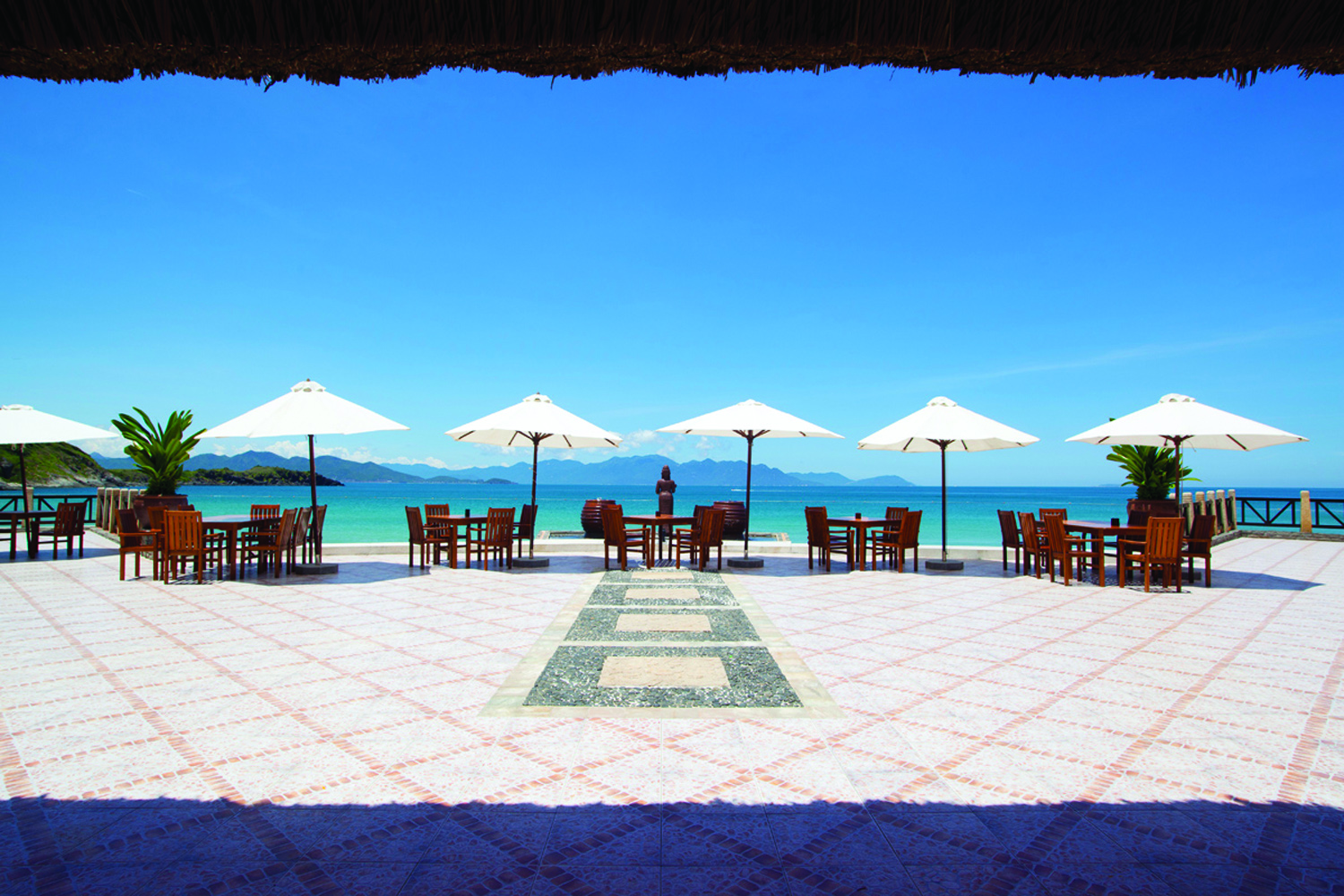 Vinpearl Luxury Nha Trang Vietnam beach view dining terrace tables chairs umbrellas