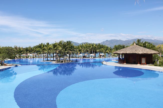 Vinpearl Luxury Nha Trang Vietnam pool palm trees mountains in background