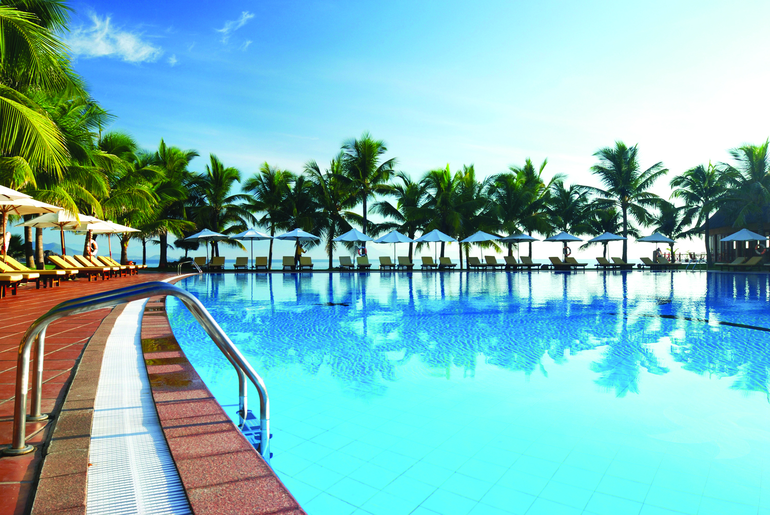 Vinpearl Luxury Nha Trang Vietnam poolside sun loungers umbrellas palm trees