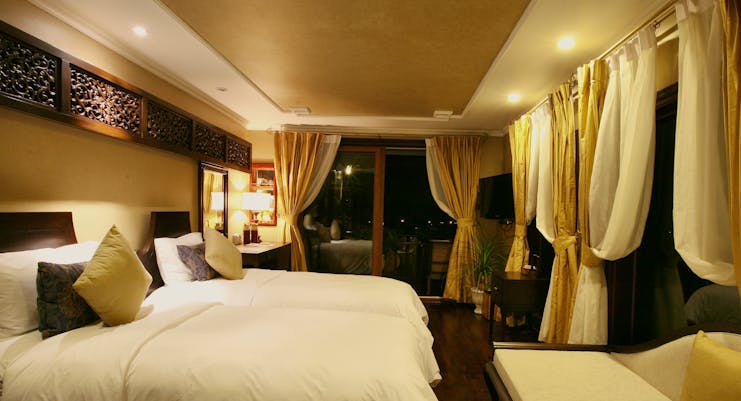 Violet Cruise junior suite, twin beds, traditional decor, large windows, curtains