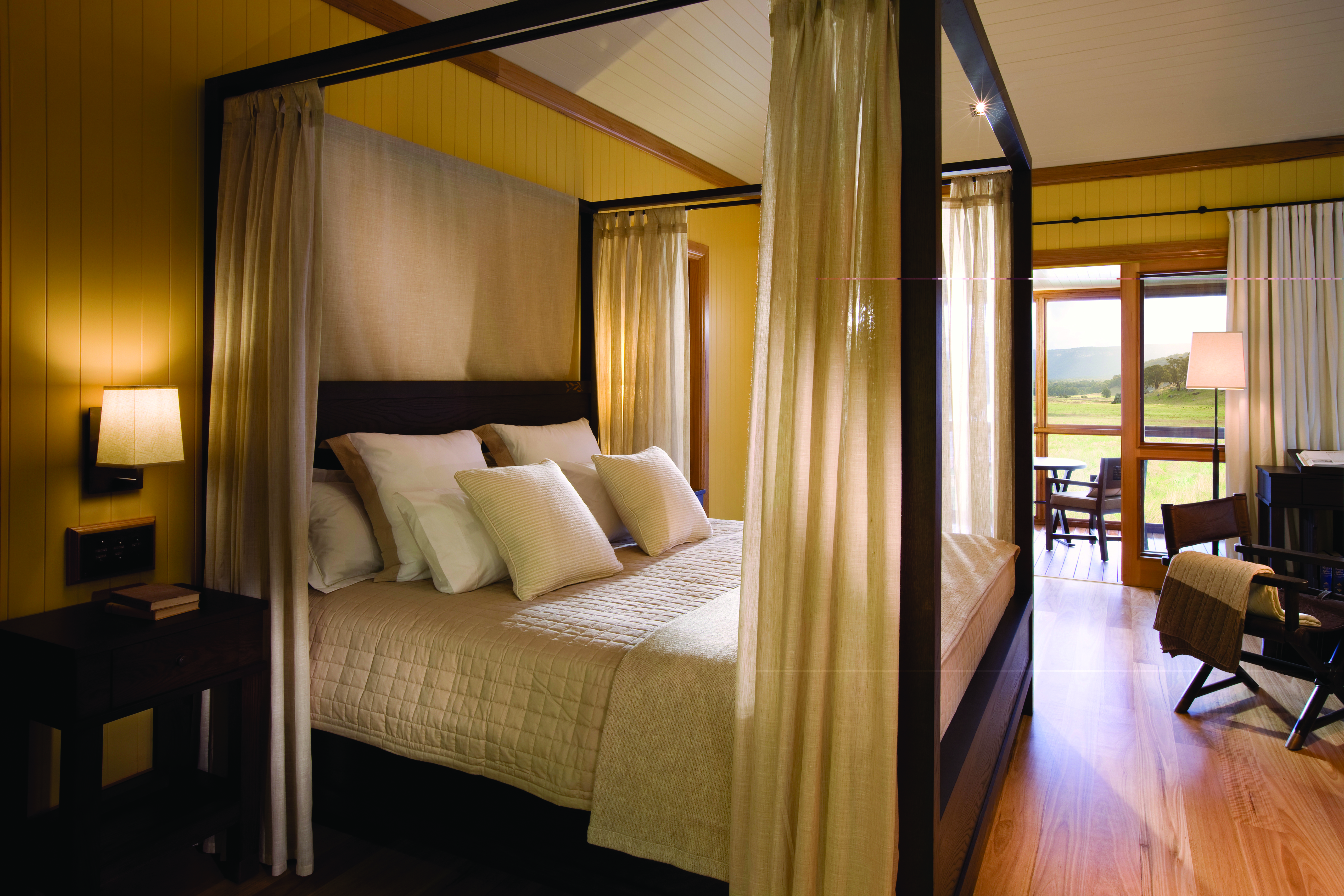 Bedroom with four poster bed and balcony