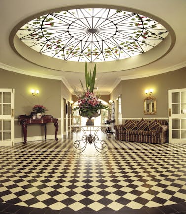 Sebel Kirkton Park New South Wales lobby area with sofa table with flowers and glass ceiling