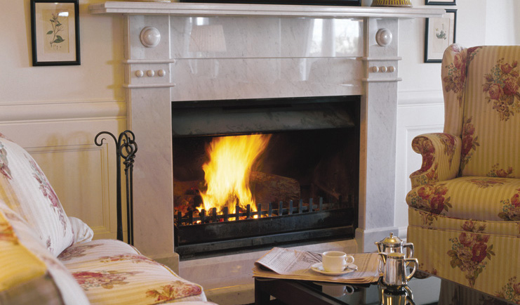 Lilianfels New South Wales lounge two floral armchairs next to a fireplace with fire
