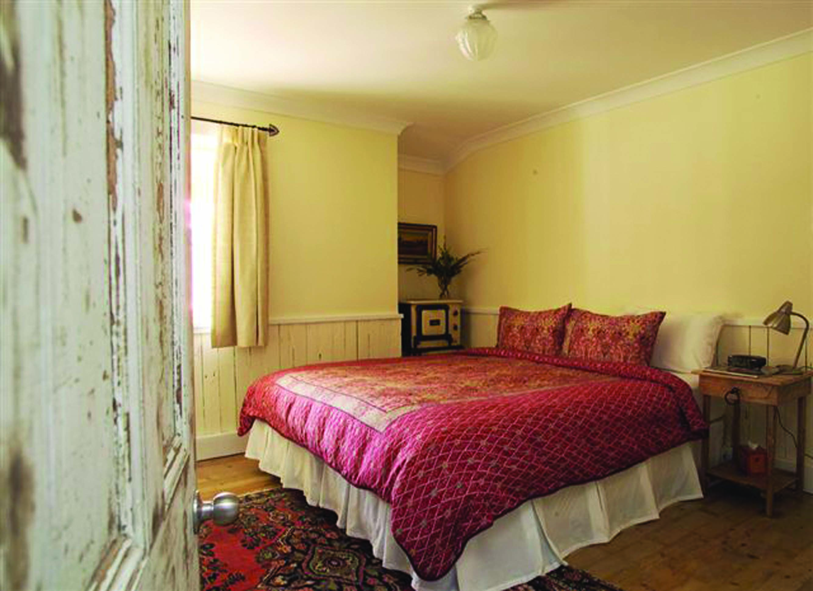 Old Leura Dairy New South Wales Mooroom rustic bedroom with wood panelled walls and wood floors 