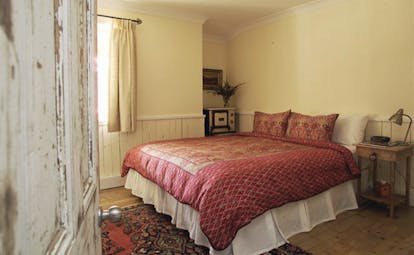 Old Leura Dairy New South Wales Mooroom rustic bedroom with wood panelled walls and wood floors 